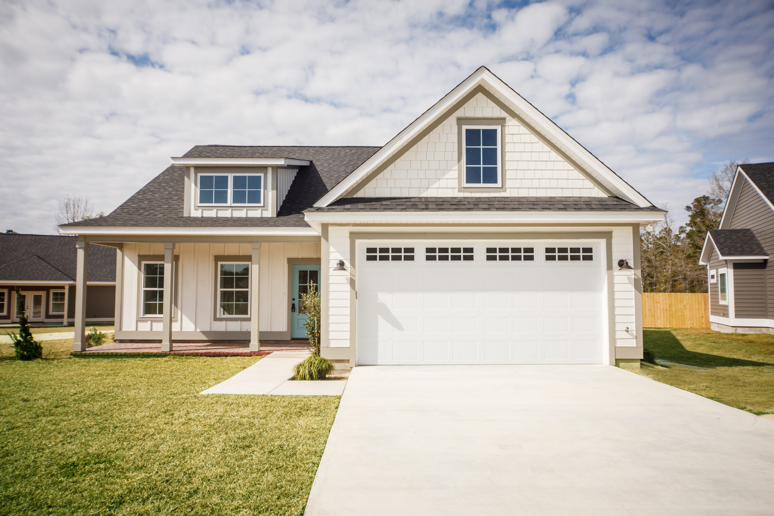 Modern new Construction White Siding Cottage House for Sale in Suburbs with Turquoise Door